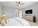 Main bedroom featuring a neutral palette, accent pillows, and a view into the ensuite bathroom at 8951 Sw 58Th Street Rd, Ocala, FL 34481