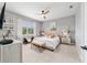 Serene main bedroom with a tufted headboard, soft lighting, and neutral decor for a relaxing retreat at 8951 Sw 58Th Street Rd, Ocala, FL 34481