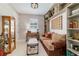 A cozy office featuring a brown couch, built-in shelves and decorative accents at 8951 Sw 58Th Street Rd, Ocala, FL 34481