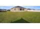 Spacious backyard showcasing the home's rear exterior and a large lawn at 9074 Se 48Th Court Rd, Ocala, FL 34480