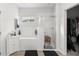 Bright bathroom with a soaking tub, glass-enclosed shower, and tiled walls at 9074 Se 48Th Court Rd, Ocala, FL 34480