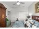 Comfortable bedroom with soft floral bedding and armoire at 9074 Se 48Th Court Rd, Ocala, FL 34480
