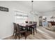 Cozy dining area with a dark wood table, four chairs, and modern lighting at 9074 Se 48Th Court Rd, Ocala, FL 34480