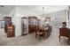 Elegant dining room with a wooden table, china cabinets, and a decorative chandelier at 9074 Se 48Th Court Rd, Ocala, FL 34480