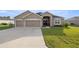 Charming home with a well-maintained lawn and a two-car garage, offering curb appeal and convenience at 9074 Se 48Th Court Rd, Ocala, FL 34480