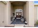 Welcoming front porch featuring seating and a double door, inviting guests into the home at 9074 Se 48Th Court Rd, Ocala, FL 34480