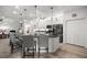Modern kitchen featuring white cabinets, sleek black appliances, and an island with barstool seating at 9074 Se 48Th Court Rd, Ocala, FL 34480