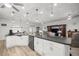 Bright, open kitchen with white cabinets, pendant lighting, and a large island for entertaining at 9074 Se 48Th Court Rd, Ocala, FL 34480
