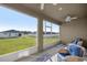 Enclosed lanai featuring comfortable seating and views of the backyard at 9074 Se 48Th Court Rd, Ocala, FL 34480