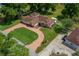Drone's eye view of a house, with circular driveway, lush lawn, and mature trees, and backyard outbuilding at 10337 Sw 74Th Ter, Ocala, FL 34476