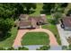Charming single-story home with a circular driveway, lush landscaping, and detached garage at 10337 Sw 74Th Ter, Ocala, FL 34476
