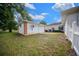 Backyard view of the detached two-car garage with brick trim and partial view of the home at 10337 Sw 74Th Ter, Ocala, FL 34476