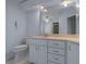 Bathroom featuring a white vanity with ample storage and a large mirror at 10337 Sw 74Th Ter, Ocala, FL 34476