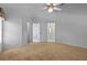 Carpeted bedroom offering a ceiling fan and access to an en-suite bathroom at 10337 Sw 74Th Ter, Ocala, FL 34476