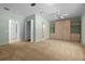 Spacious bedroom with neutral carpet, built-in storage, and ensuite access to a well lit bathroom at 10337 Sw 74Th Ter, Ocala, FL 34476