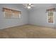 Bright bedroom with carpet flooring, two windows, and a ceiling fan at 10337 Sw 74Th Ter, Ocala, FL 34476