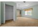 Bedroom featuring neutral carpet, built-in storage, and a large closet for ample space at 10337 Sw 74Th Ter, Ocala, FL 34476