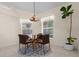 Charming breakfast nook with a glass table, seating for four, and a decorative light fixture at 10337 Sw 74Th Ter, Ocala, FL 34476