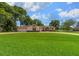 Charming single-story home with a well-manicured lawn and a circular driveway at 10337 Sw 74Th Ter, Ocala, FL 34476