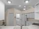 Efficient kitchen with white appliances, ample storage, and easy access to laundry area at 10337 Sw 74Th Ter, Ocala, FL 34476