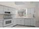 Bright kitchen showcases white cabinetry, stainless steel appliances, and a convenient layout at 10337 Sw 74Th Ter, Ocala, FL 34476