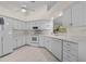 Well-lit kitchen features all-white cabinetry, modern appliances, and ample counter space at 10337 Sw 74Th Ter, Ocala, FL 34476