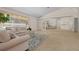 Bright living area with comfortable seating, complemented by a large window and mirrored wall at 10337 Sw 74Th Ter, Ocala, FL 34476