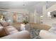 Spacious living room boasts a mirrored wall, plush sofas, and stylish area rug at 10337 Sw 74Th Ter, Ocala, FL 34476