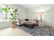 Comfortable living room with a plush sofa, patterned rug, and a large window, offering a cozy gathering space at 10337 Sw 74Th Ter, Ocala, FL 34476