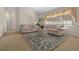 Comfortable living room featuring neutral furnishings, stylish rug, and bright natural light from the large window at 10337 Sw 74Th Ter, Ocala, FL 34476