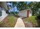 Outbuilding with double doors, perfect for storage or workshop, in a well-maintained yard at 10337 Sw 74Th Ter, Ocala, FL 34476