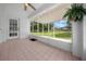 Cozy screened porch with tile floors, ceiling fan, and views of the lush backyard at 10337 Sw 74Th Ter, Ocala, FL 34476