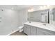 The main bathroom features a dual sink vanity and walk-in shower with tiled walls at 10374 Se 126Th Ln, Belleview, FL 34420