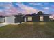 Charming single-story home with a well-manicured lawn, and an attached two-car garage at 10374 Se 126Th Ln, Belleview, FL 34420