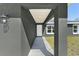 Inviting entryway with modern architectural details and a covered porch leading to the front door at 10374 Se 126Th Ln, Belleview, FL 34420