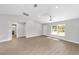 An open living area with hard wood floors, vaulted ceiling, and a window for natural lighting at 10374 Se 126Th Ln, Belleview, FL 34420