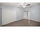 Bedroom featuring wood-look floors, a ceiling fan, and a large window at 10441 Sw 85Th Ct, Ocala, FL 34481