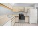 Cozy kitchen with white appliances, laminate countertops and light cabinets, offering a functional cooking space at 10441 Sw 85Th Ct, Ocala, FL 34481