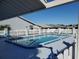 Community swimming pool enclosed by a white fence, perfect for relaxing or exercise at 10441 Sw 85Th Ct, Ocala, FL 34481
