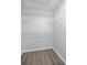 Bright walk-in closet features white wire shelving and durable wood-look flooring at 10441 Sw 85Th Ct, Ocala, FL 34481