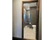 Modern bathroom featuring sleek dark gray tiling, a glass-enclosed shower, and stylish fixtures at 1047 Ne 19Th St, Ocala, FL 34470