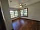 Bright bedroom with hardwood floors, complemented by large windows that provide ample natural light and scenic views at 1047 Ne 19Th St, Ocala, FL 34470