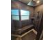 Elegant walk-in shower with sleek dark gray tiling, a built-in bench, and modern fixtures at 1047 Ne 19Th St, Ocala, FL 34470