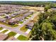 Aerial view of the property nestled in a neighborhood with mature trees and sidewalks throughout at 11136 Se 69Th Ter, Belleview, FL 34420