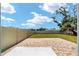 Spacious backyard with a brick patio, grassy lawn, and a privacy fence at 11136 Se 69Th Ter, Belleview, FL 34420