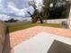 Spacious backyard with a brick patio, grassy lawn, and a playset visible in the distance at 11136 Se 69Th Ter, Belleview, FL 34420
