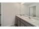Bright bathroom featuring a double sink vanity with granite countertops and modern fixtures at 11136 Se 69Th Ter, Belleview, FL 34420