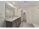 Bathroom boasts double sinks and a large mirror at 11136 Se 69Th Ter, Belleview, FL 34420