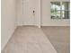 Tiled entryway with front door, adjacent to carpeted room at 11136 Se 69Th Ter, Belleview, FL 34420