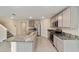 Modern kitchen with granite countertops, stainless steel appliances, and tile flooring at 11136 Se 69Th Ter, Belleview, FL 34420